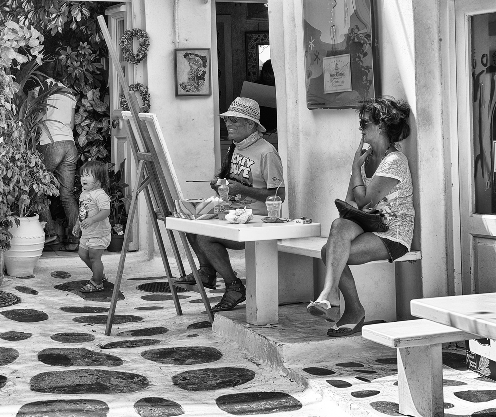 Three happy, one unhappy - Mykonos street scene. 75mm APO Summicron, 1/750s at f/9.5, ISO 320 (Photo Mike Evans)
