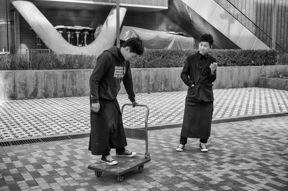 Off-duty waiters indulge in a spot of cart-boarding in Beijing