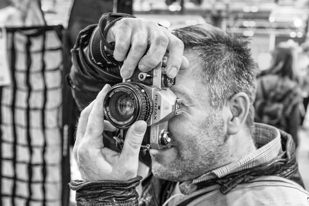 Not many vintage cameras to be seen among all the digital delights and unfeasibly long telephotos. But this was a particularly fine example of a film photographer at work with his humble nifty fifty from a bygone age. (Fuji X100S, ISO 3200)