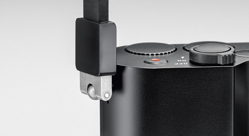 The supplied silicon strap has proprietary connectors for the new lug sockets. If you fit a wrist strap there is no vacant lug visible on the other side of the camera