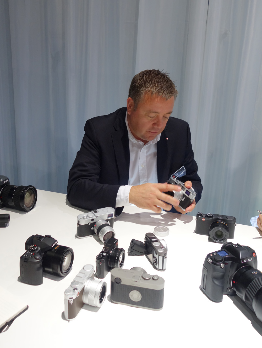 The £12,000 M60 flanked by the M-P, the X, the D-Lux, the revamped X-E and the latest S, Note how the V-Lux looks like a mini S (photo Michael Pritchard )