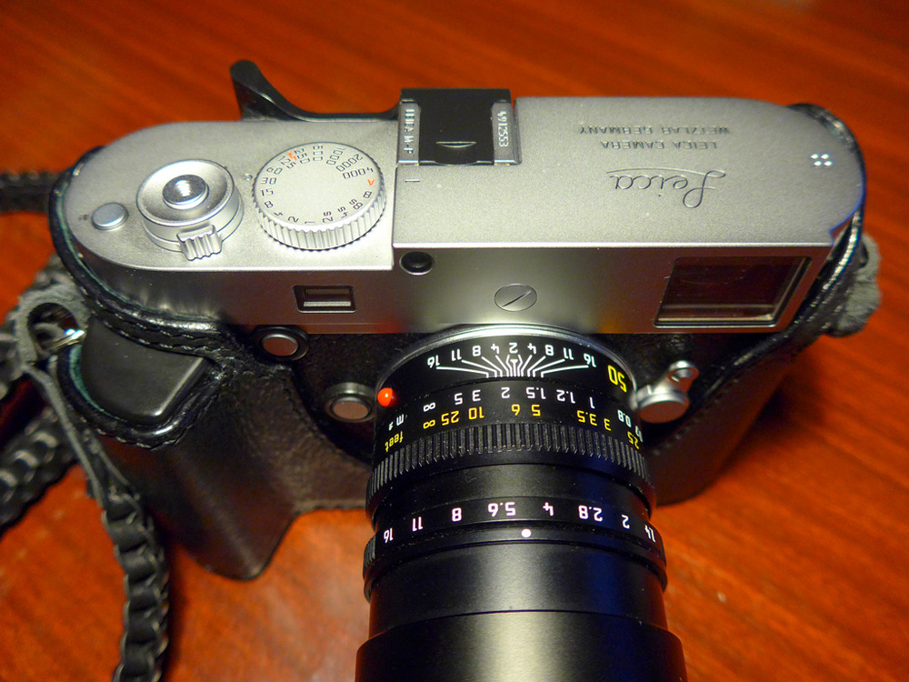   The gip case adds extra bulk to the standard Leica grip and allows the fingers to hold on, especially when toting the camera in your right hand. Note that the edge of the case skirts round the new frameline lever  