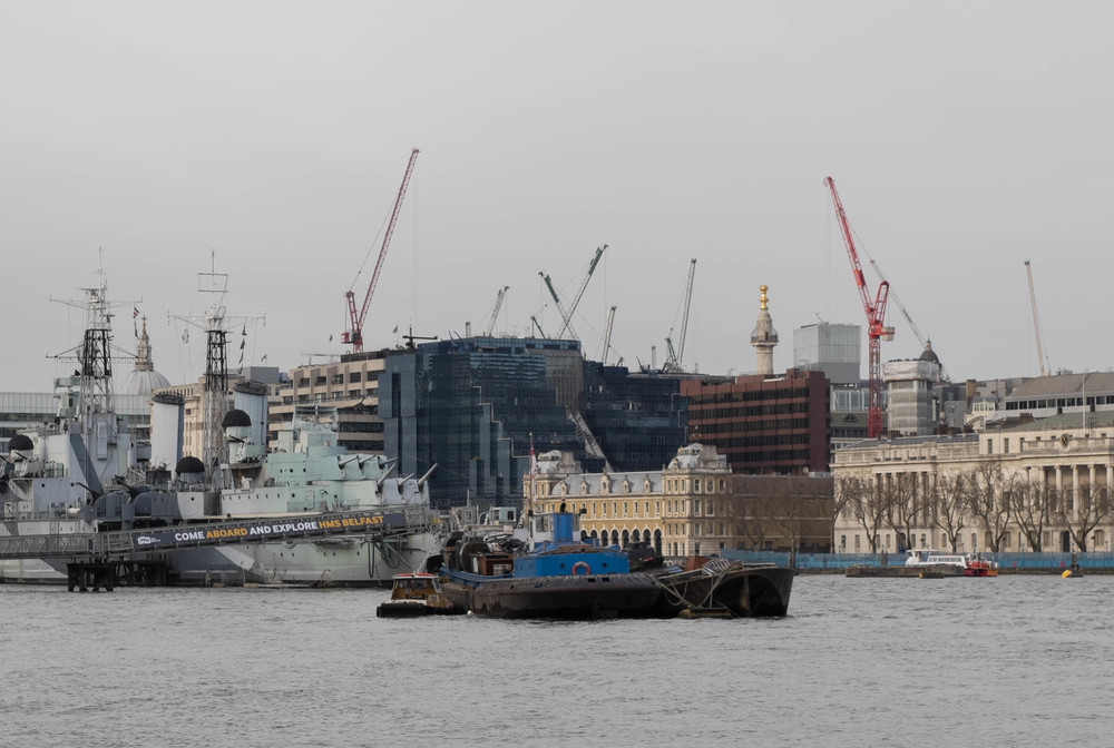   Monument of cranes: The golden orb of The Monument, erected to commemorate the Great Fire of London in 1666, is lost amid the 21st Century skyline. In the foreground, HMS Belfast. Fuji again.  