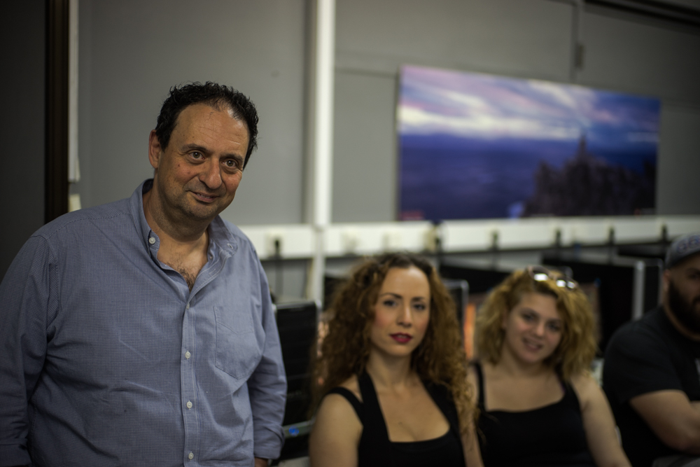 Manos Lykakis, the digital media instructor, with two of his students