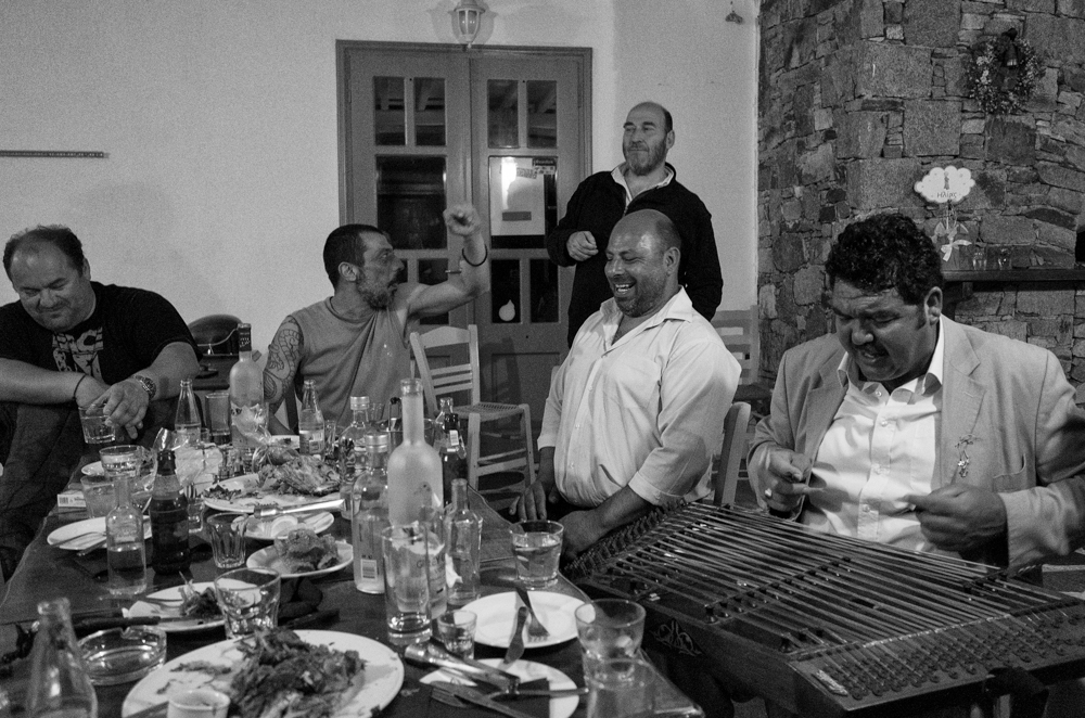   And to end the evening, gate crashing an all day (and night) baptism at  Balothies  in Ornos, one of the finest Cretan restaurants in the Cyclades. The womenfolk and the newly baptised infant, Ilias, had long since found their beds but I joined the party after midnight and we were knocking back the  raki  until 3 am. Note the ancient  santouri  (Ricoh GR)  