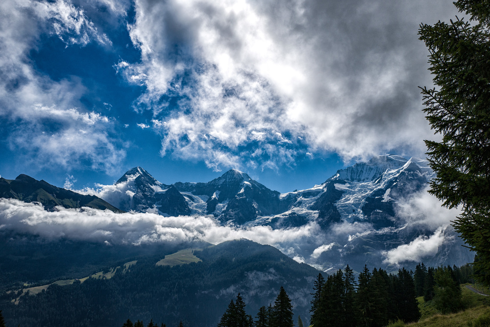 The three strong men of the Bernese Oberland—Eiger, Mönch and Jungfrau (partly hidden by clouds). See the Jungfraujoch buildings in the saddle between Mönch and Jungfrau. This is Europe