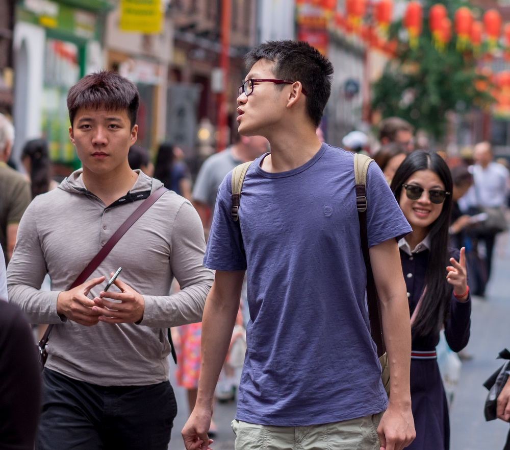  X-T10 and 56mm f/2 at 1/2700s. Some subjects are more eager than others to be photographed. Note the girl in the background. She had already spotted the camera and was grooming herself for stardom even as I snapped these two guys in Chinatown. Then check the shot at the top of this story. It was taken within two seconds of this first picture and it is a testament to the quick autofocus of the X-T10 that I was able to switch over and reframe so rapidly.  
