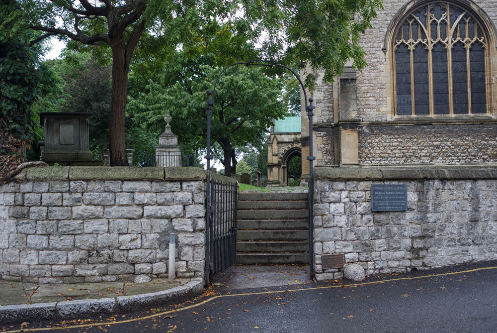 Slightly above high-water mark, the quiet churchyard of St. Nicholas passes the centuries