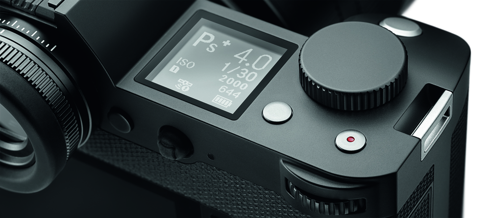 S styling cues in the massive circular eyecup and the top-mounted information panel
