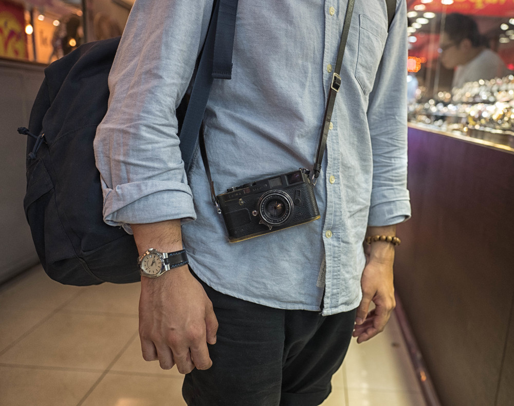  Nice watches, nice cameras: I am struck by the number of interesting old Leicas dangling around necks all over Hong Kong. This is a particularly fine example of the genre: A well brassed M4-P and Summicron sets off the watch to perfection. I am told by Sam Lok (see below) that the owner of the brassed M4P is none other than 2011 Leica Award winner, Huang Jie. Well spotted, Sam 