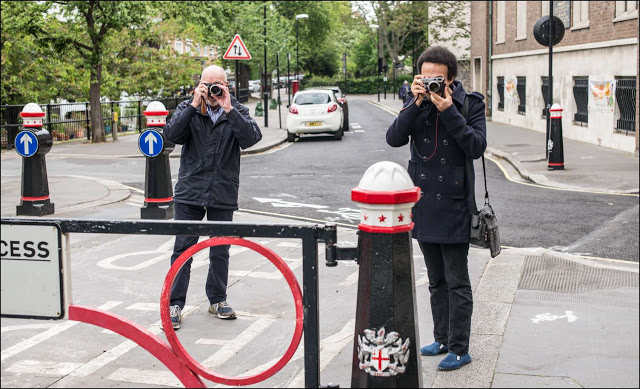 Mike (left) and Adam Lee (right) grabbing the above group shot from a distance. Picture by Nick de Marco