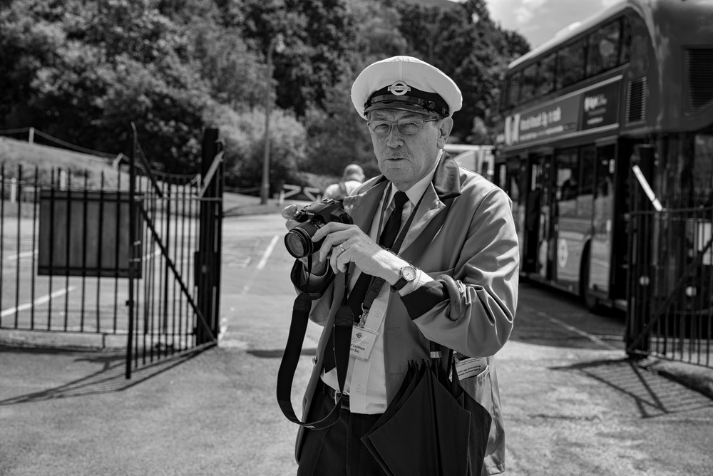 Peter Larkham, secretary of the London Bus Museum, also in full uniform (with brolly) and busy recording the event.