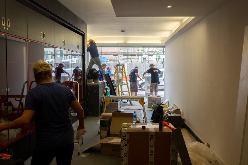 Coordination: Cleaning, installing the alarm system, adding the new graphics and painting—everyone working against the clock to be ready for Monday morning