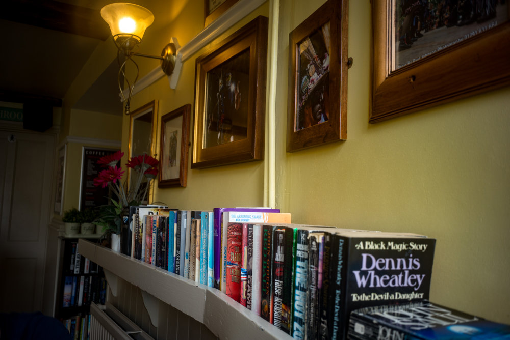 A wide depth of field at f/8. The books in the foreground are just inside the 1m minimum focus distance of this lens. This is something you need to watch out for when using zone focus. When using the rangefinder you would get a warning and step back a little unless you actually want the near foreground to be fuzzy.