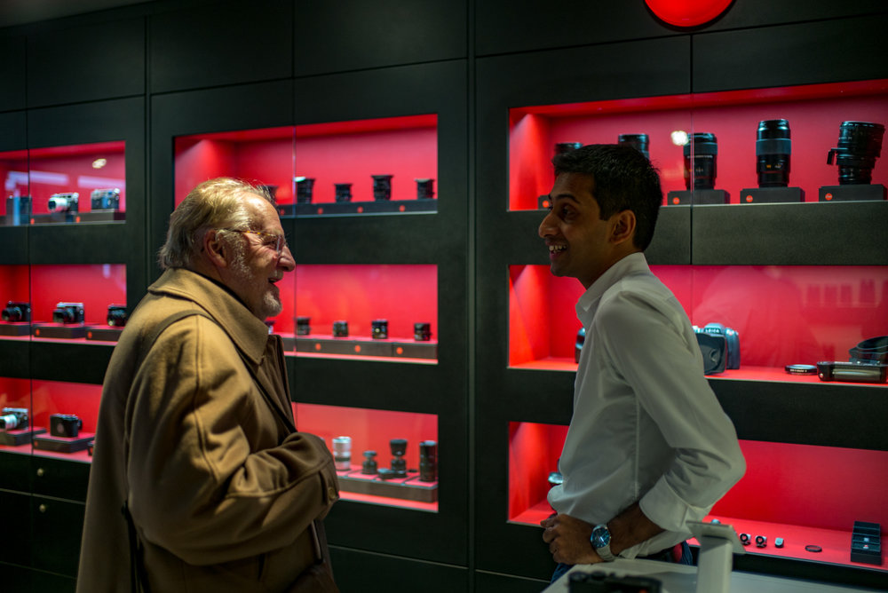 Leica Society chairman Brian Oliver negotiates a deal with store manager Vijay Sebastian.