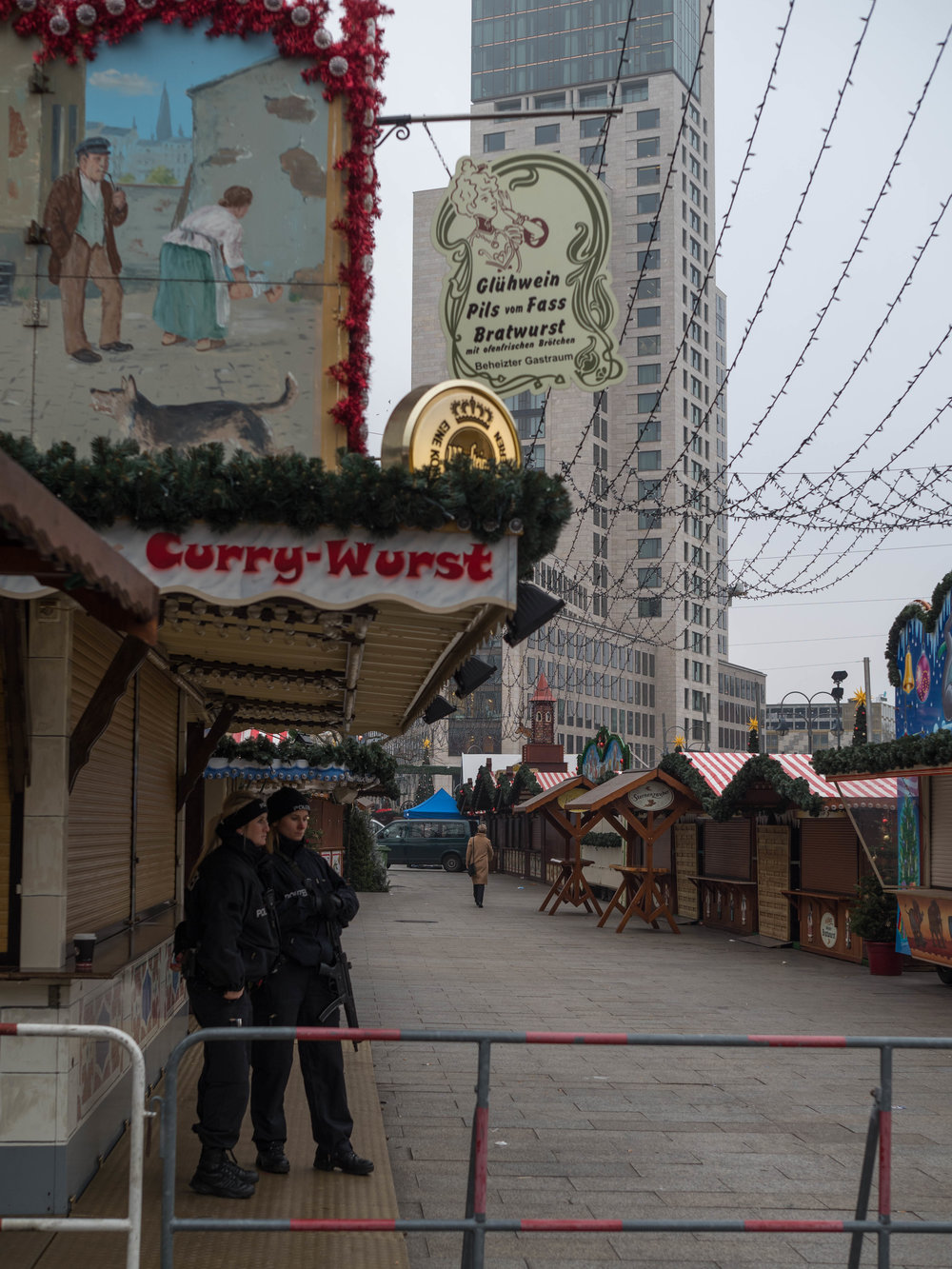 Last night thousands were here for a currywurst or a glass of traditional Glühwein. This morning, empty stalls, policewomen with machine guns.