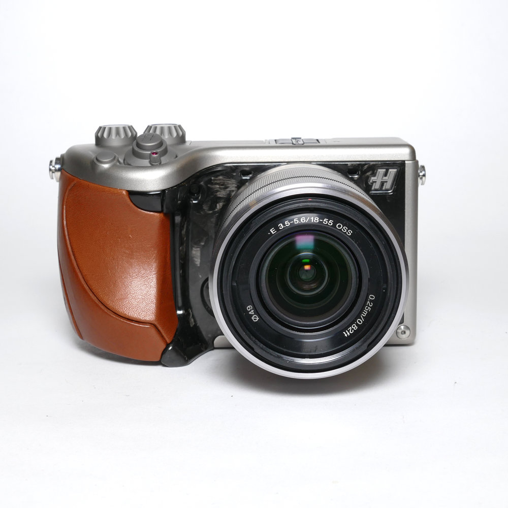 One of the many, many versions of the Lunar. This is a relatively tasteful piece with leather grip and fingerprint-style carbon fibre coating. That 18-55 zoom is a modest performer, unworthy of a six-grand camera.