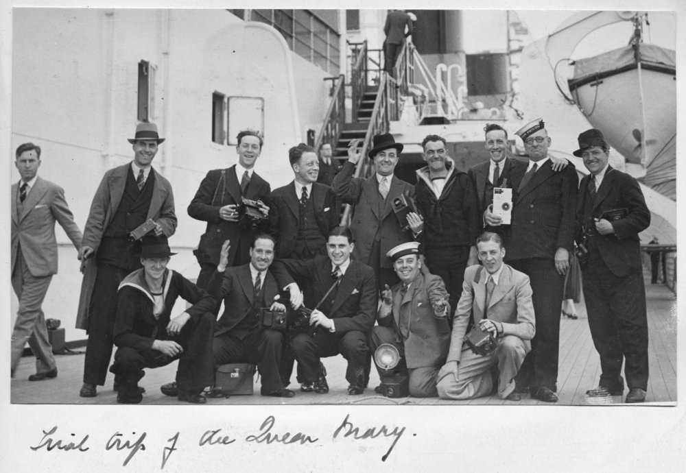   [Fig.7] Press Photographers aboard The Queen Mary on its trial trip, circa 1936. The cameras have been enlarged below to show more detail. Numbers 1-3 show the row standing at the back from left to right. Numbers 4-7 show the row kneeling from right to left. One is using a flash bulb. Click on the inividual images to see full size  