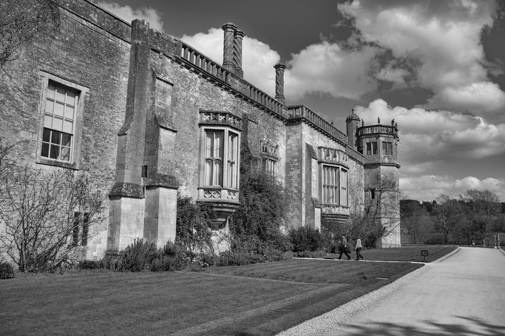 Above: Lacock is an odd mix of 13th-century abbey and Tudor mod-cons. The famous oriel window can be seen in the centre, above the bushes and in line with the footpath