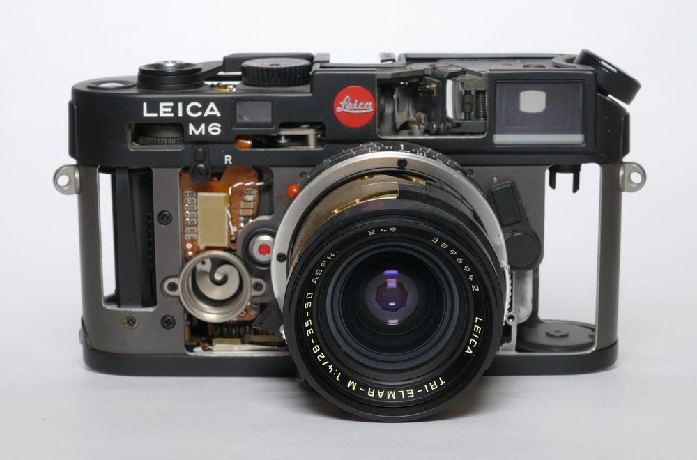 A Schnitt Leica M6 with a cutaway Tri-Elmar-M. The interesting thing here is that this lens is in full working order, despite its skeletal appearance. It reminds me to handle mine with extra care!