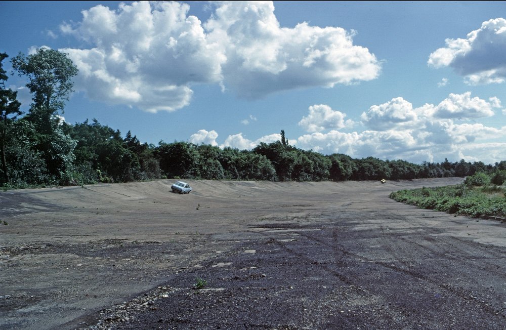   A couple of modern (that is, early 1970s) cars attempting the banking. The further one appears to have overdone things a bit. Definitely not a Bentley Boy at the helm  