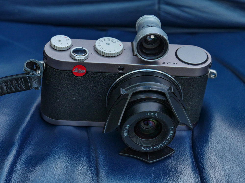 My Leica X1 is now for sale, with the automatic lens hood (an aftermarket version) but without the Voigtländer viewfinder shown here