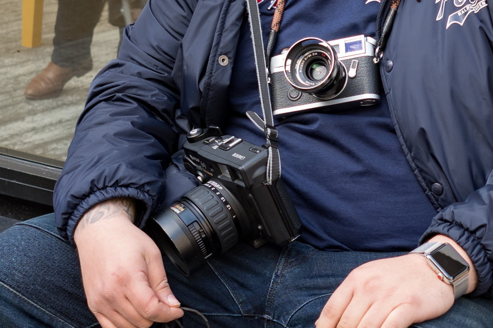 Not only does Nico carry his pristine Leica M7 with a well-used Zeiss Biogon 35mm, but for even more detail he hefts the Fuji 6x9in GW690 III. Incidentally, I approve of the Apple Watch Series 3. It provides a wonderful contrast to the old-school photography gear