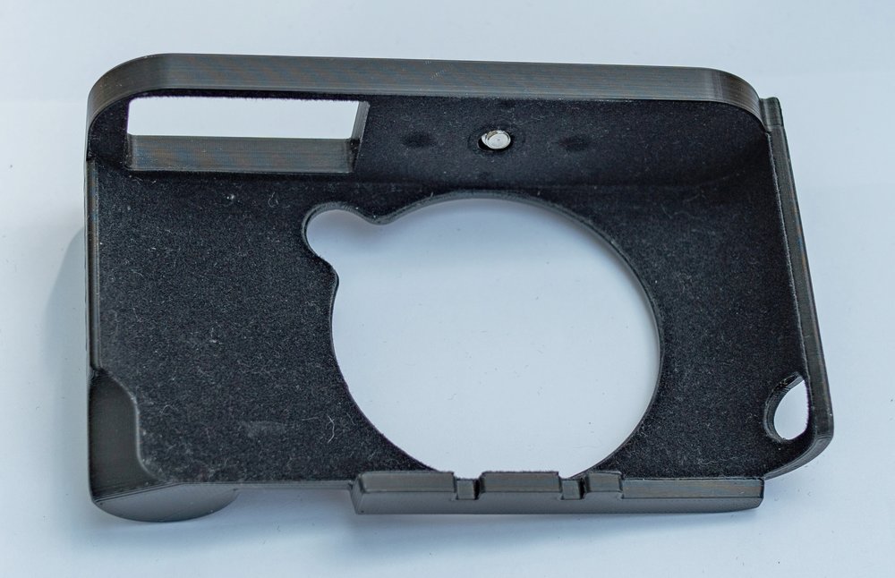 The case is 3D printed from ABS and fits the camera with precision. The cutout for the batter compartment is visible in this shot