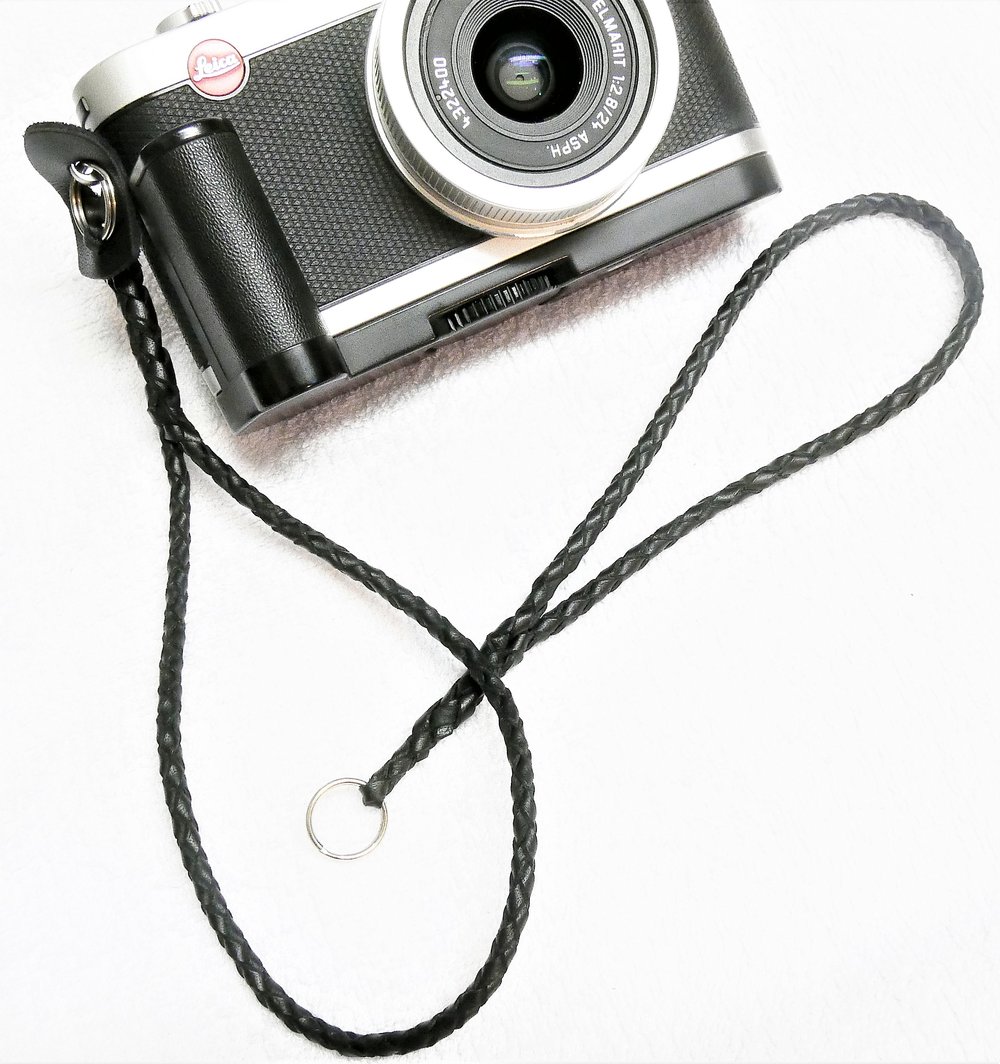   The first camera wrist strap, made from 3mm lacing and attached to the Leica X2, crafted by an expert. The unattached strap is my novice attempt. It will go on the Leica D-Lux.  