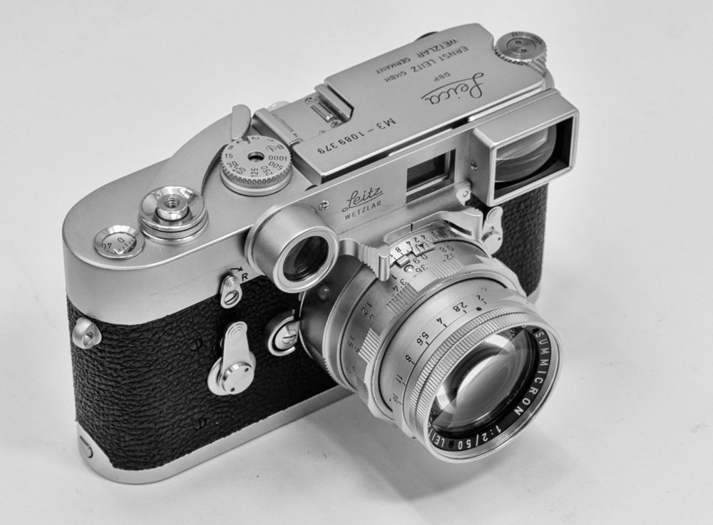 The Leica M3, the archetypal rangefinder camera, introduced in 1953. This pristine example is fitted with the dual-range Summicron and “specs”. Image Red Dot Cameras, London