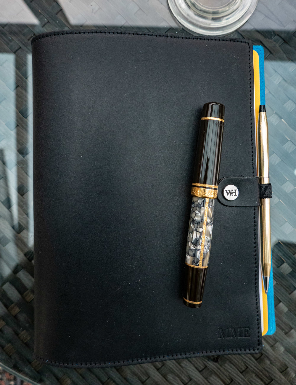 The William Hannah A5 notebook closed. The vintage Cross ballpoint pen fits the pen loop perfectly and is ideal for travelling. But for erious writing I prefer a fountain pen, such as the Montblanc. Note the monogram — a small extra charge when ordering your cover.