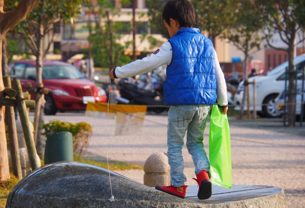 Amazingly sad, for me; a boy with his teeny, faithful (Space Shuttle?) toy. Not a dog, not a cat, but a bit of plastic pet on a string. For me, besides the bright colours, it’s a picture of an imaginary friend, a world of his own. Nagasaki, Japan.