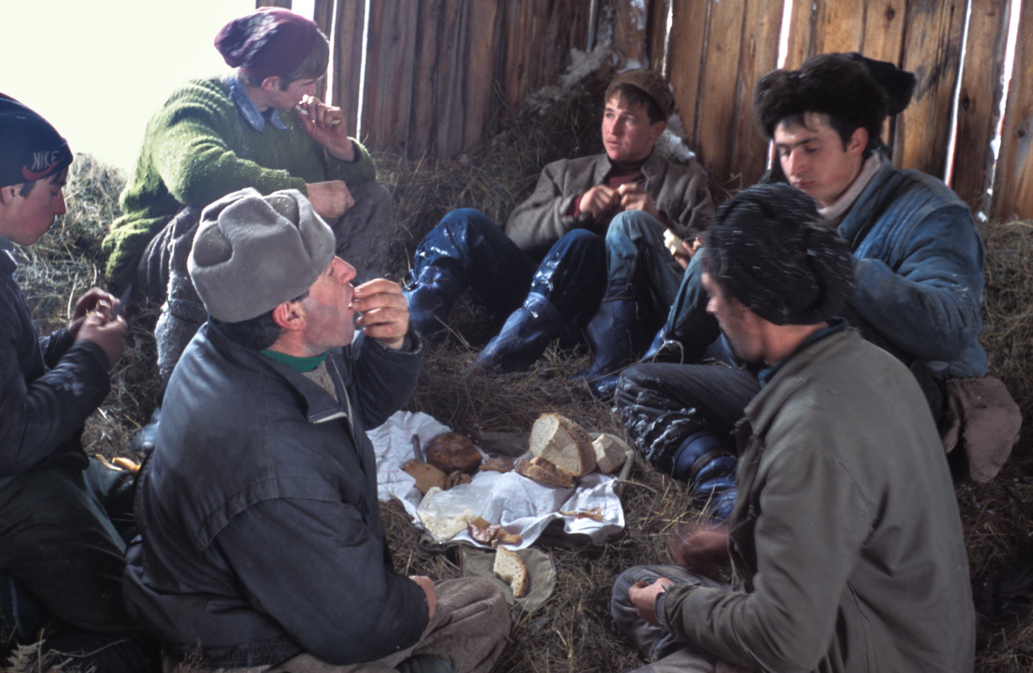 Men eating in a bark in midwinter above the village of Jidegsegpataka Transylvania Romania after loading their sledges (Leica M6 and 35mm f/1.4 Summilux)