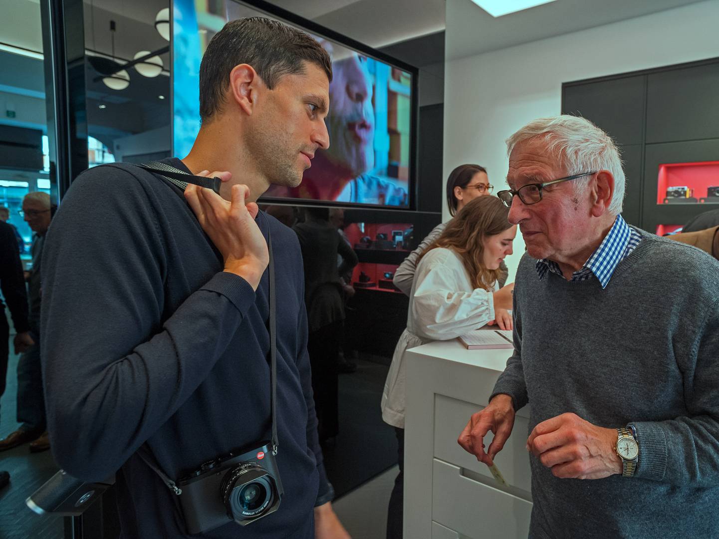 Chris Angeloglou chatting with Leica Ambassadord Robin Sinha. Louise in the background taking oders for David Suchet's book, Behind the Lens.