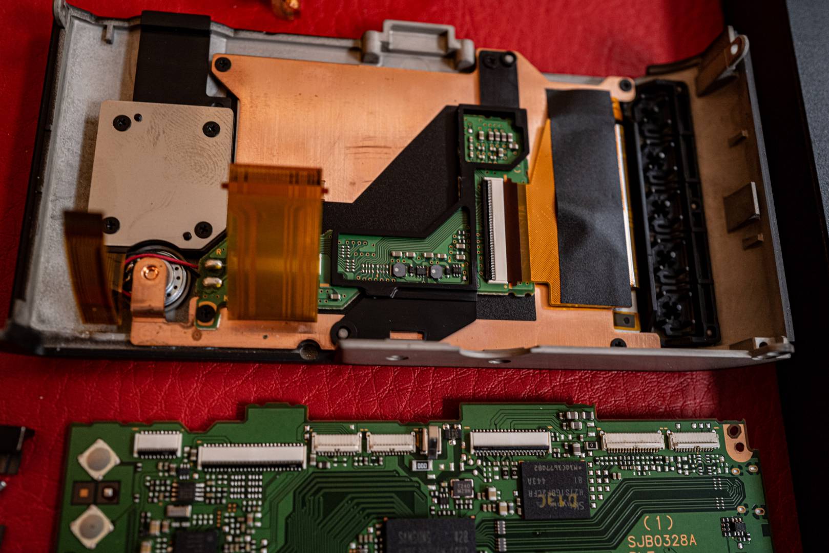 Back of the camera and motherboard. Note again the back of the rear buttons (top right) and the corresponding contacts on the main board (bottom left)