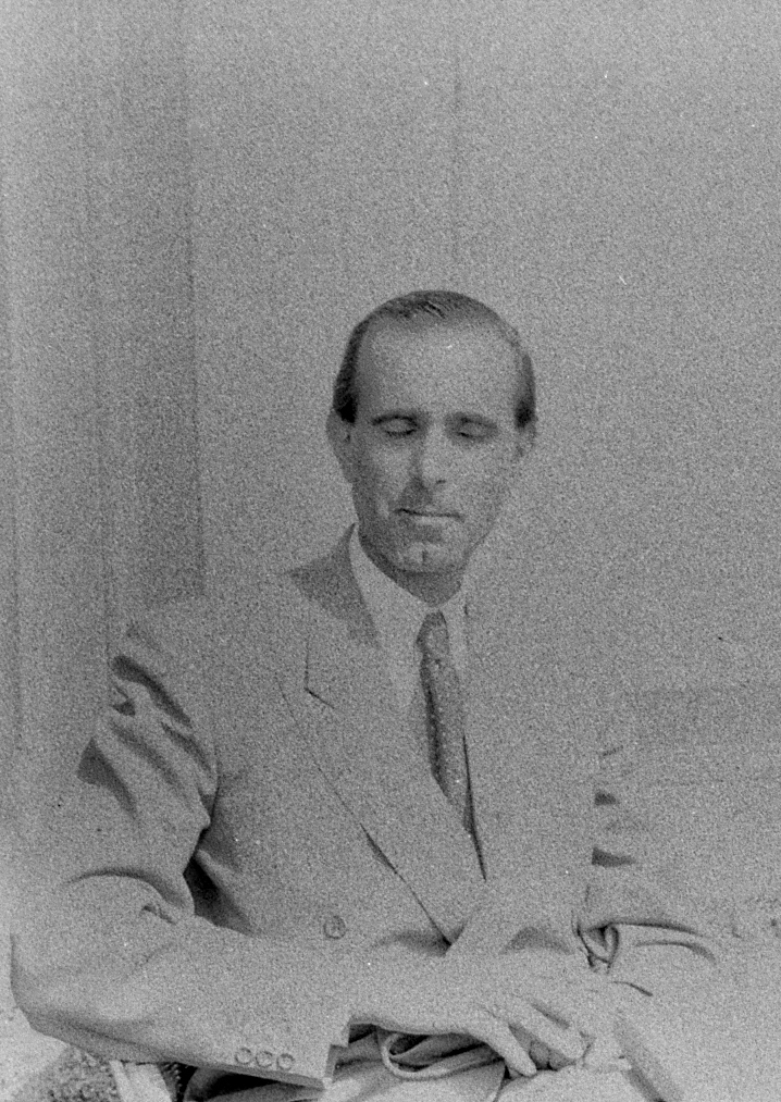 A man with his eyes closed as the shutter flashes; a man with a distinctive aristocratic demeanor and a chin dimple. This picture was taken on a Leica III outside a bar in Lenno 70 years ago. If we could trace this man, millions around the world would be delighted