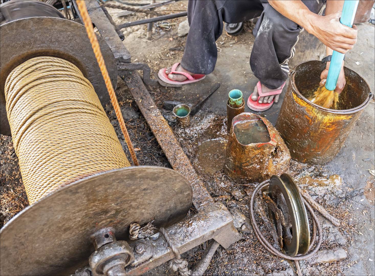 Emptying the oil from the pipe into a jerry can