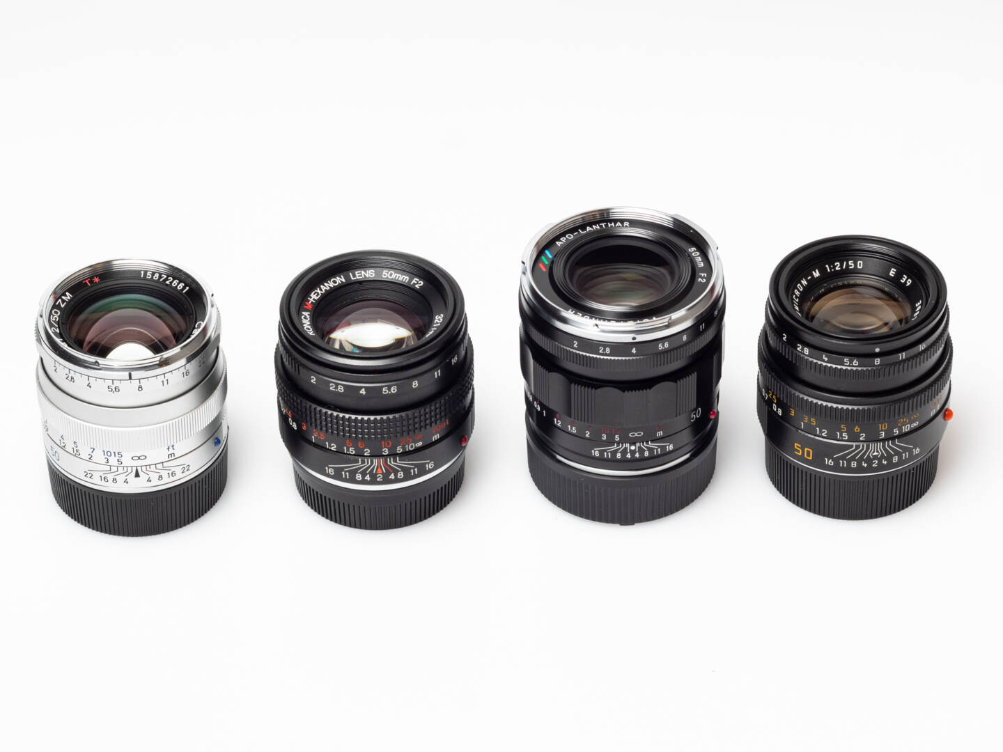 Zeiss Planar 50/2 (left) and three alternatives of the same focal length and speed: Konica M-Hexanon 50/2, Voigtländer Apo-Lanthar 50/2, Leica Summicron 50 (from left to right). But what about…?