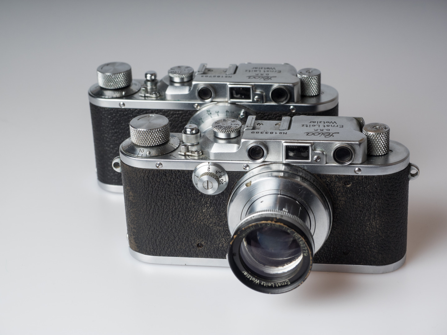Veterans: Leica III, with the additional dial for the long exposure times (front left) and strap lugs, and behind an older Leica II that lacks both features