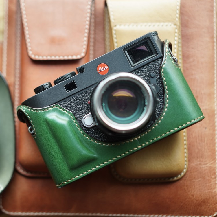 Let the fancy take you. I was taken with this green case but eventually asked Sejun to make a totally vanilla black case with black stitching. Note that this case is the standard design with no bottom flap and is secured to the camera with two press-stud "ears" above the strap lugs