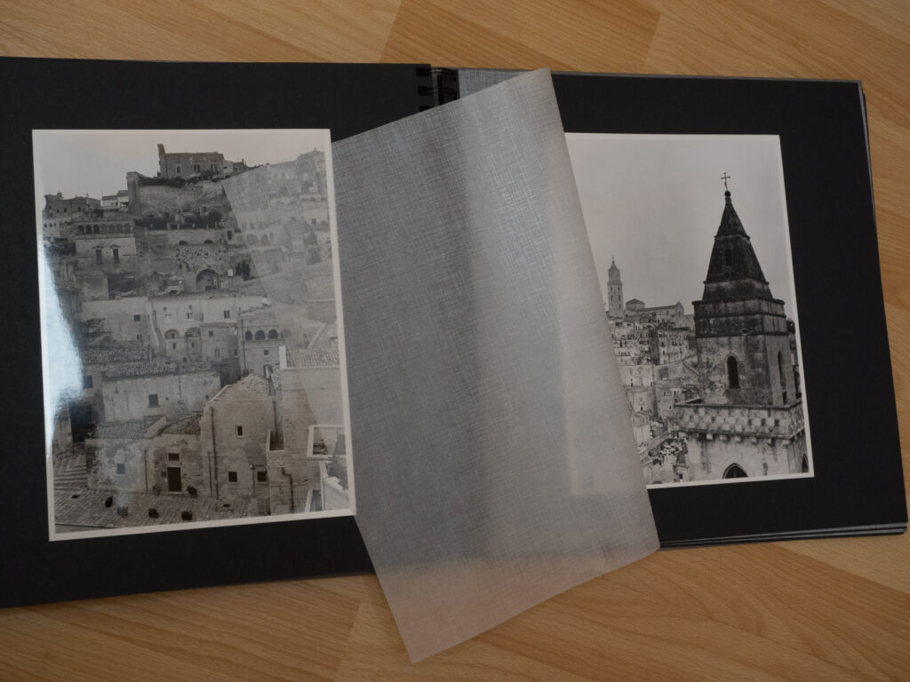 Image shows an album with hand-made b/w prints