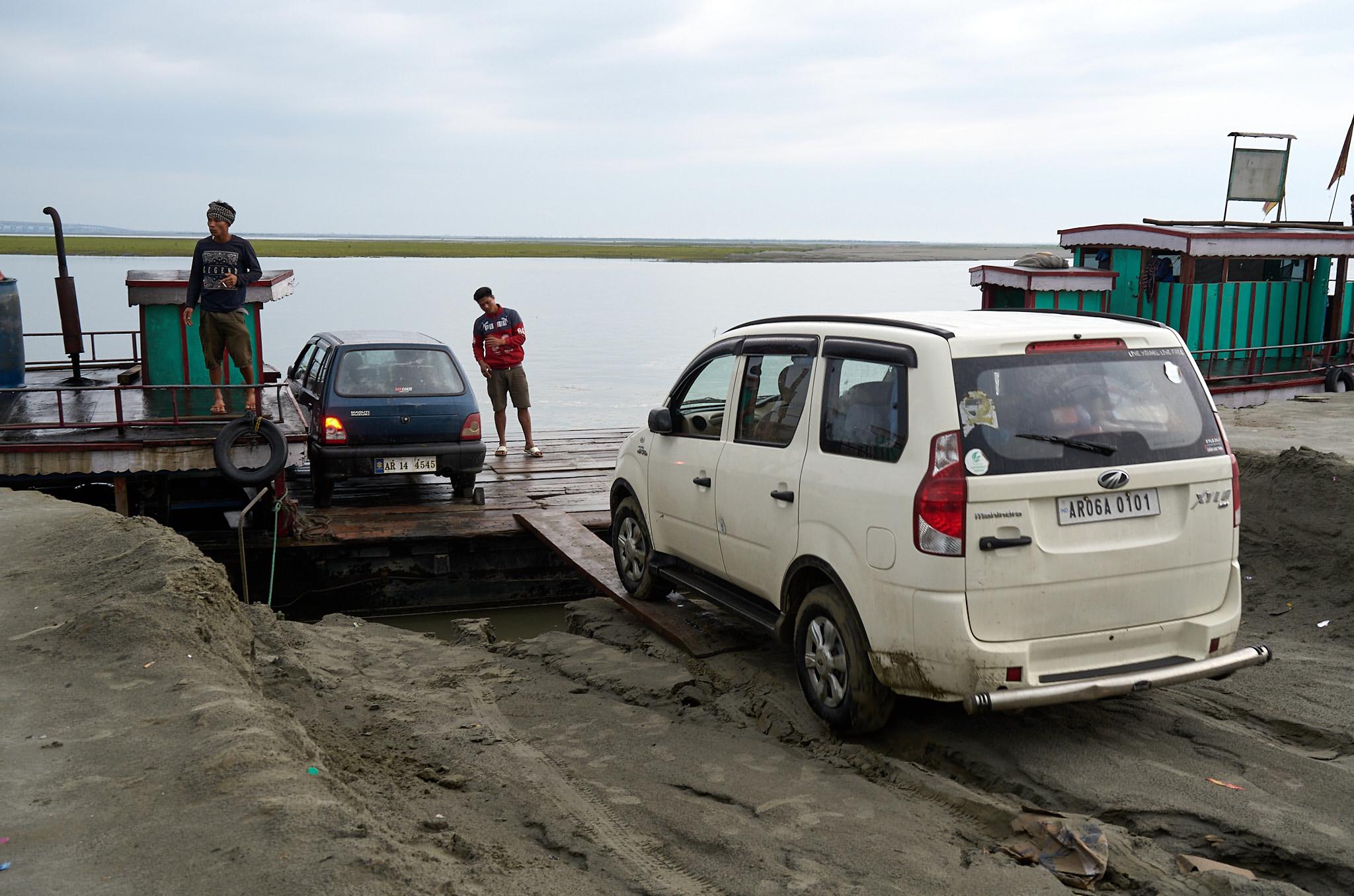 cars waiting to board ferry over the Sisseri River, Assam