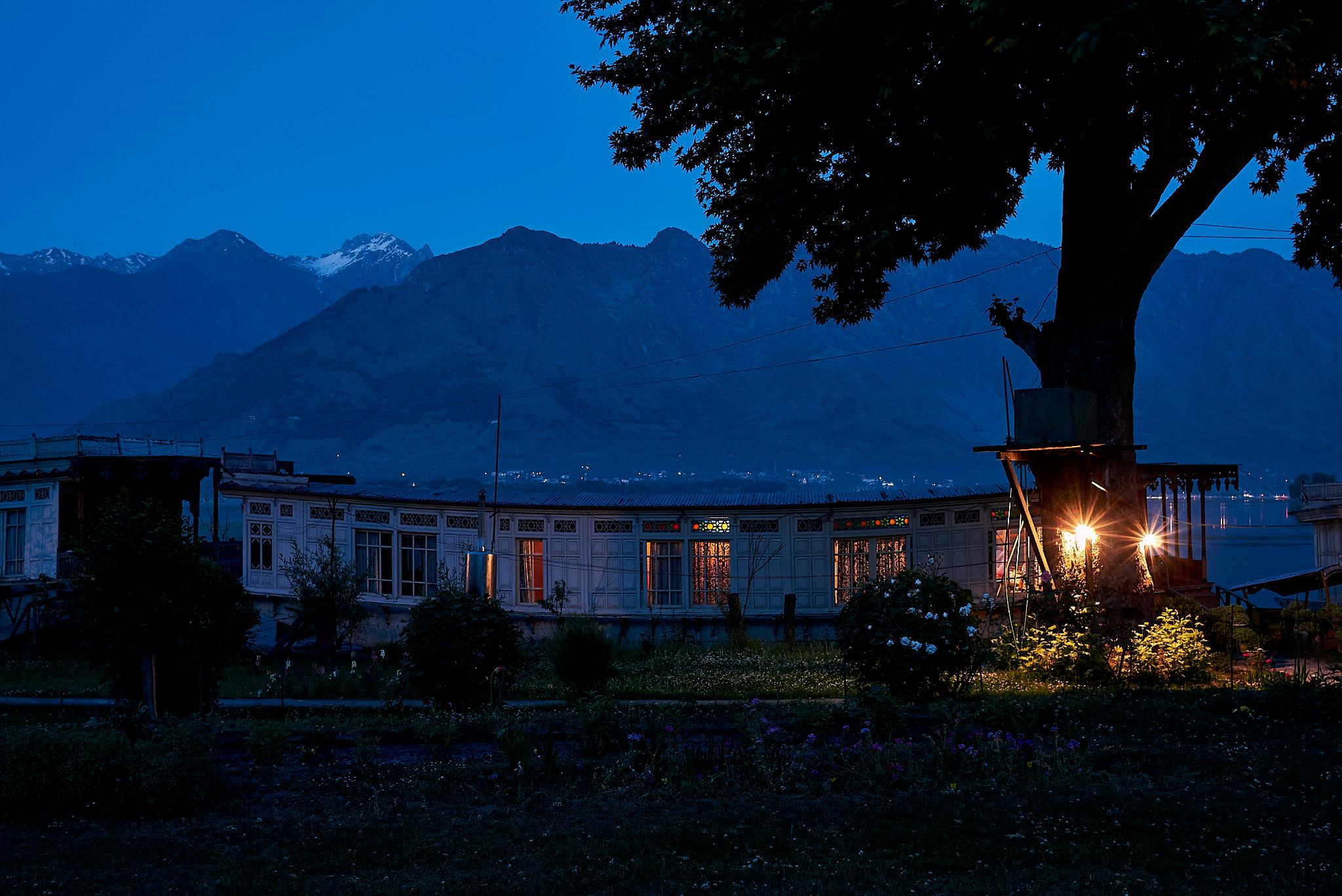 Khushal our two bedroom houseboat against a backdrop of the Zabarwan range