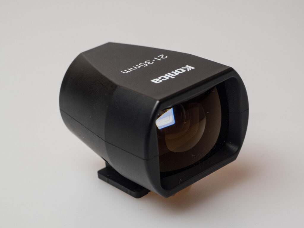 Product image shows one of the attachable viewfinders made by Konica