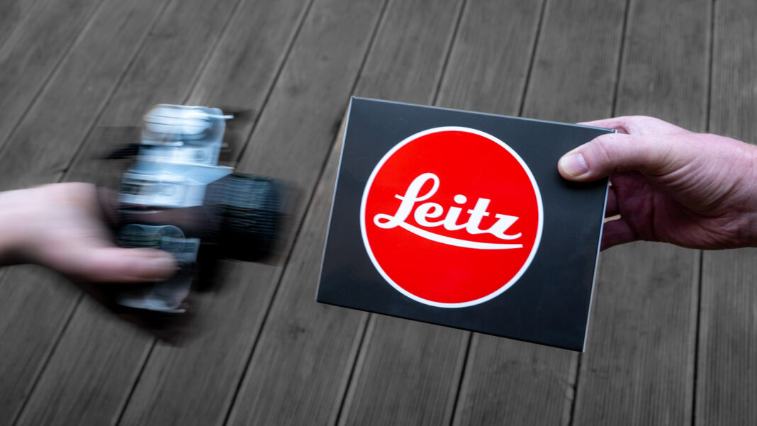 Image shows an old Canon SLR camera being exchanged for a brand new Leica M6.