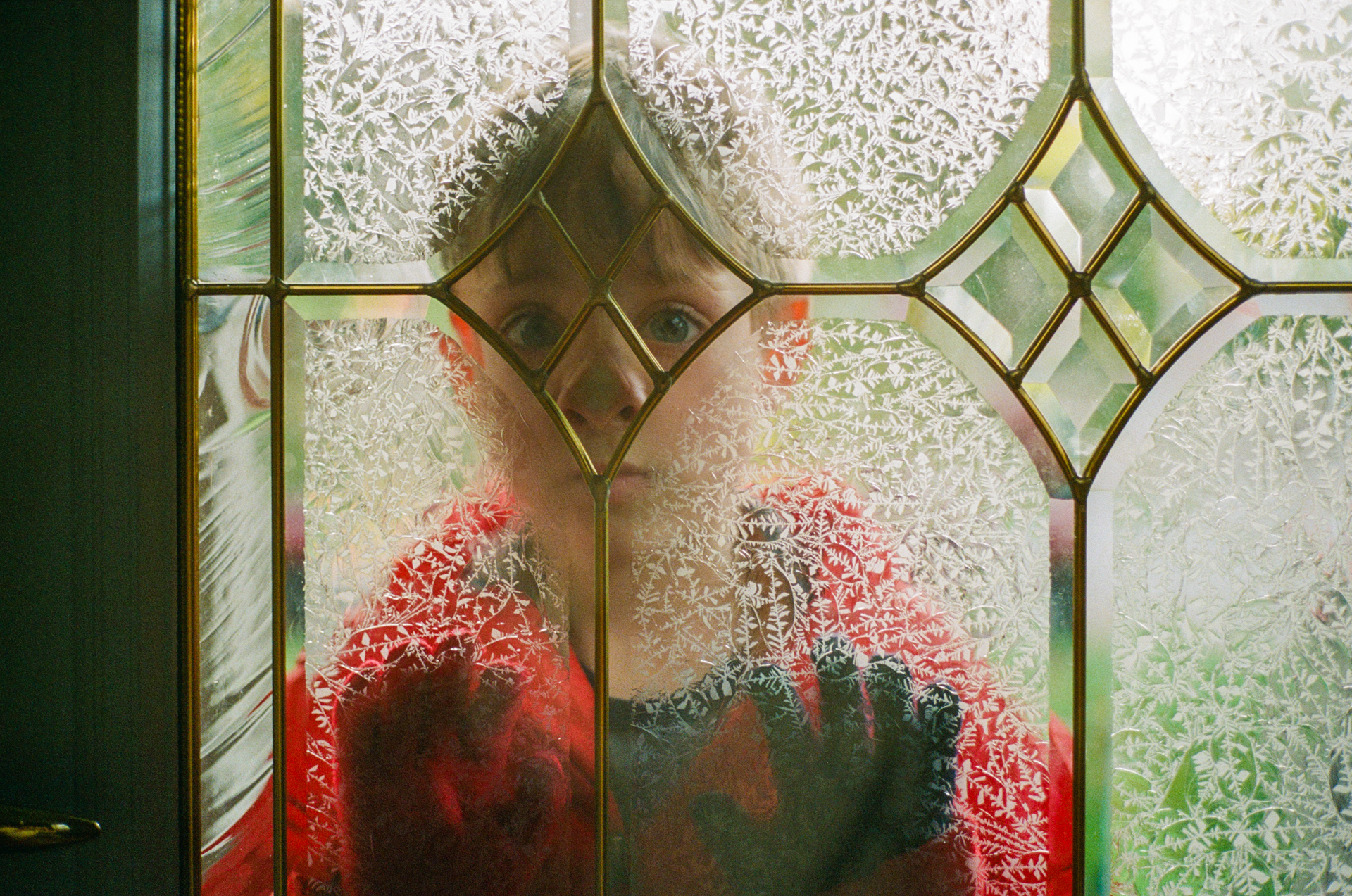 Boy looking through window