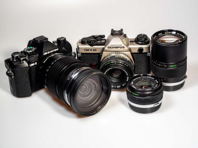 product shots shows OM System OM-5 digital camera, Olympus OM-4 Ti analogue camera and respective lenses