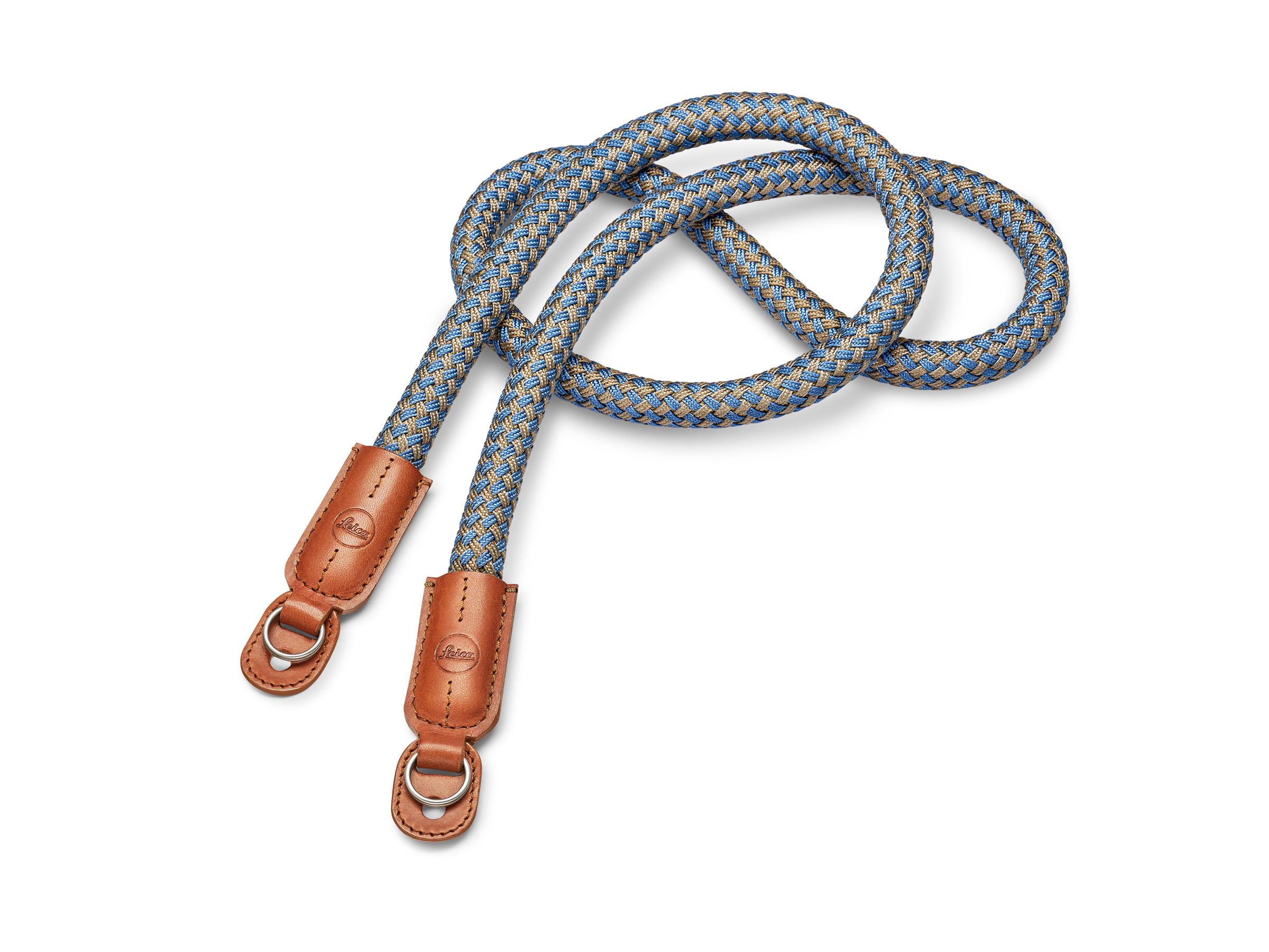 A braided camera strap in blue and beige tones, featuring leather accents at both ends with metal clips.