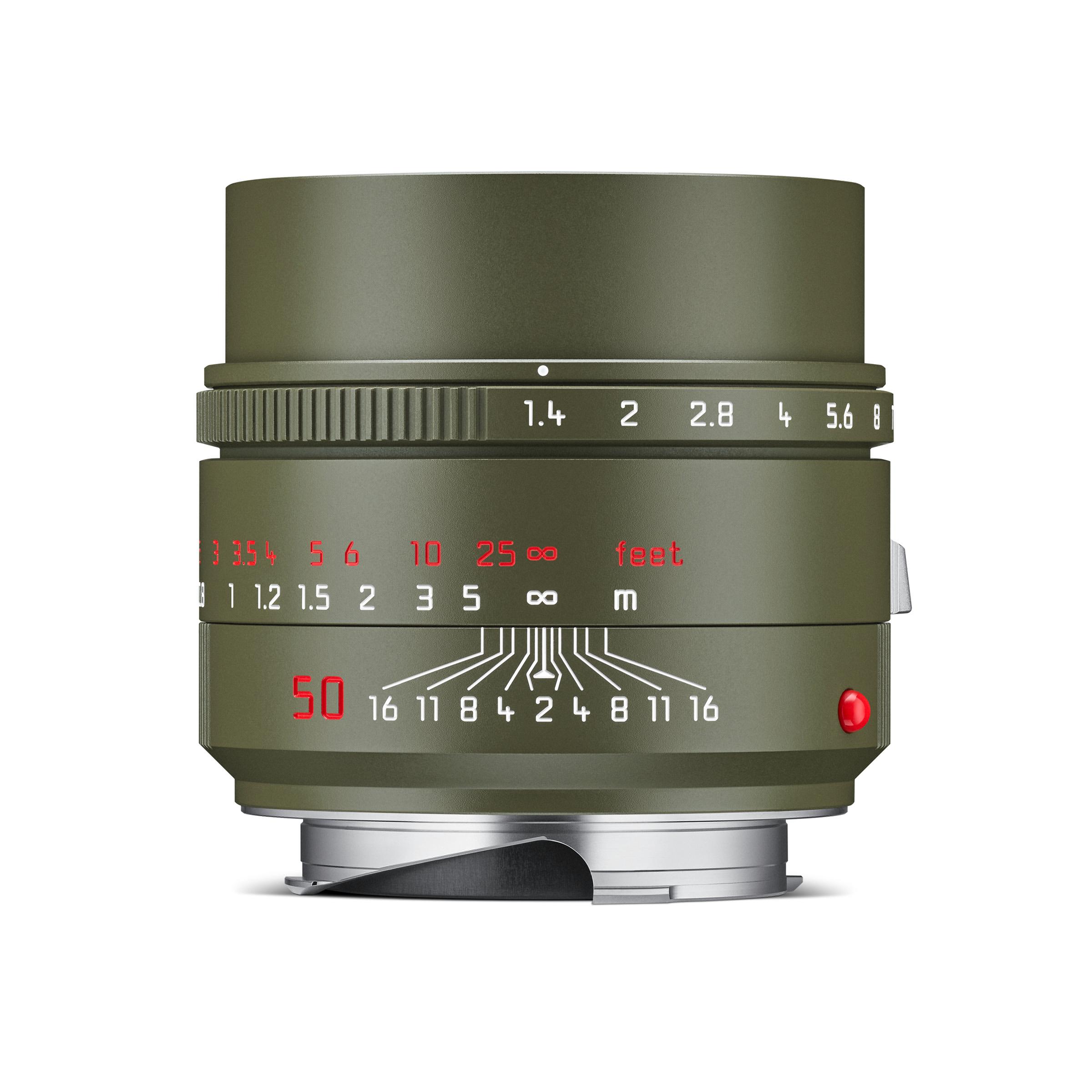 A side view of the Summilux-M 50 f/1.4 ASPH Safari lens featuring a matte olive green finish, red markings, and a brass silver-chrome mount.