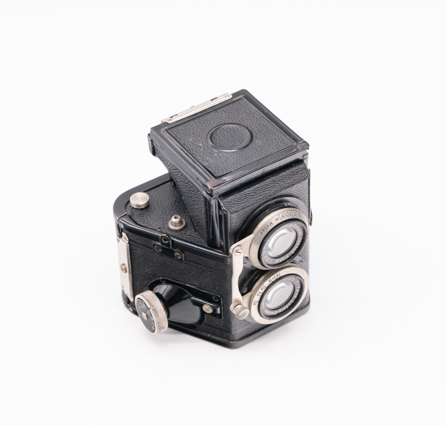 Black twin lens reflex camera with a square top and dual lenses on the front, showcasing vintage design elements.